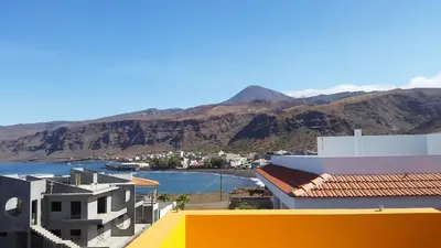 a view of a city with mountains and a body of water at Casa Patio in Tarrafal