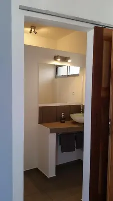 a bathroom with a sink and a mirror at Casa Patio in Tarrafal