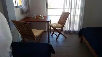 a room with a table and two chairs and a bed at Casa Patio in Tarrafal