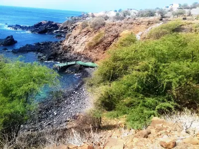 a bridge on the side of a cliff near the ocean at Pousada Villa Concetta AC in Cidade Velha