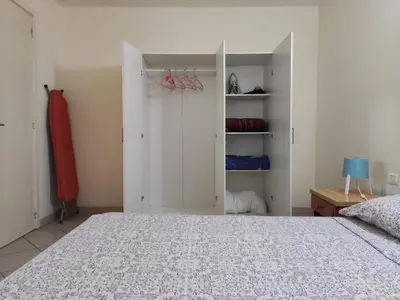 a bedroom with a bed and a closet at Residence Amanda with pool in Santa Maria