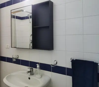 a bathroom with a sink and a mirror at Residence Amanda with pool in Santa Maria