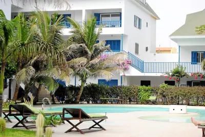a swimming pool with two chairs and a building at Residence Amanda with pool in Santa Maria