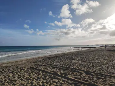a beach with the ocean on a cloudy day at Residence Amanda with pool in Santa Maria