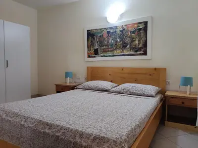 a bedroom with a bed and two night stands at Residence Amanda with pool in Santa Maria