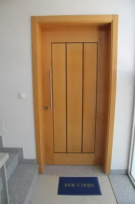 a wooden door with a sign in front of it at Apartamento Rita in Praia