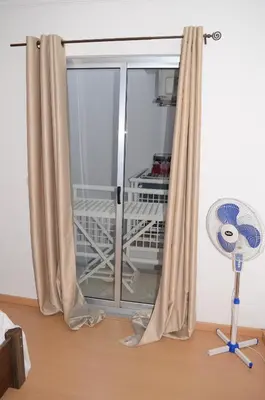 a room with a window with a fan at Apartamento Rita in Praia