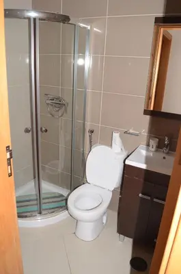 a bathroom with a shower and a toilet and a sink at Apartamento Rita in Praia
