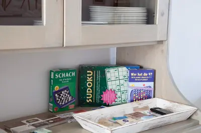 a shelf with books and games in a cabinet at Nos Kasa in Sal Rei