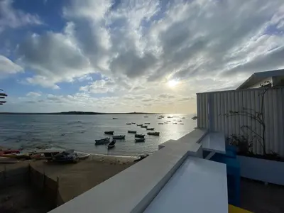 a group of boats in the water on the shore at Nos Kasa in Sal Rei