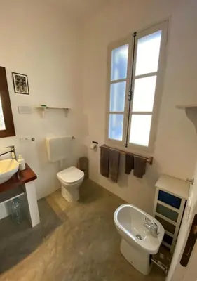 a white bathroom with a toilet and a sink at Nos Kasa in Sal Rei