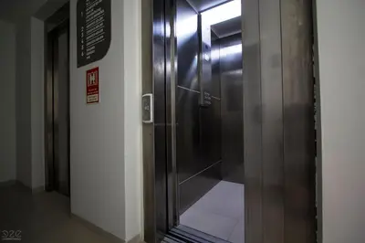 a elevator in a building with a glass door at Tiduca Hotel in Ponta do Sol