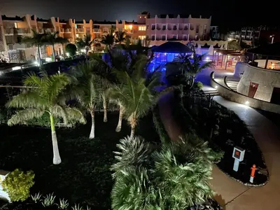 an aerial view of a resort at night with palm trees at Apartment | in Tropical Resort | pool | close to beach in Santa Maria