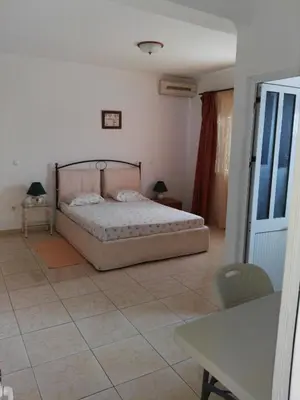 a bedroom with a bed and a tiled floor at Casa da Luz - Appartement in Mindelo