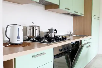 a kitchen with a stove with pots and pans on it at PORT DO SOL-free wi-fi no limits in Sal Rei