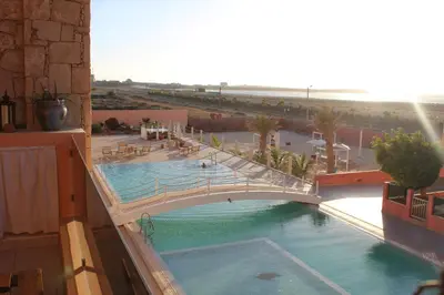 a bridge over a swimming pool in a building at PORT DO SOL-free wi-fi no limits in Sal Rei