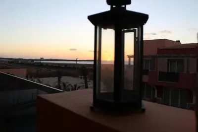 a light on a balcony with the sunset in the background at PORT DO SOL-free wi-fi no limits in Sal Rei