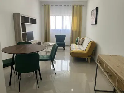 a living room with a couch and a table and chairs at Tarrafal Guest House in Tarrafal