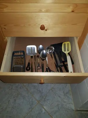 a drawer full of kitchen utensils in a cabinet at Casa Azul One Rua da Morna Santa Maria in Santa Maria