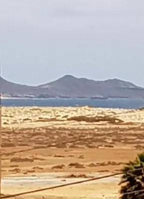 a view of a desert with the ocean and mountains at Casa Azul One Rua da Morna Santa Maria in Santa Maria