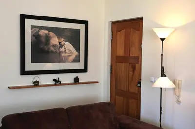 a living room with a couch and a picture on the wall at Bouganville in Mindelo