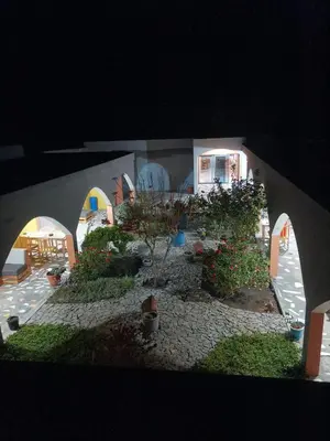 a house with a garden in front of it at night at casa alcindo in Portela