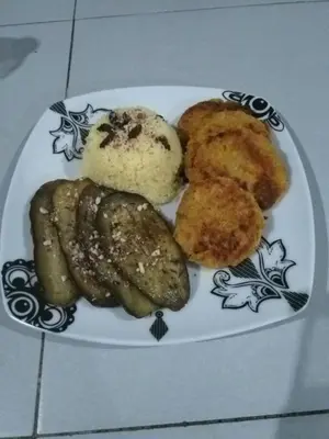 a plate of food with sausage and potatoes on a table at casa alcindo in Portela