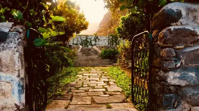 a stone path with a gate and stairs at Casa Santa Barbara Deluxe in Ribeira Grande
