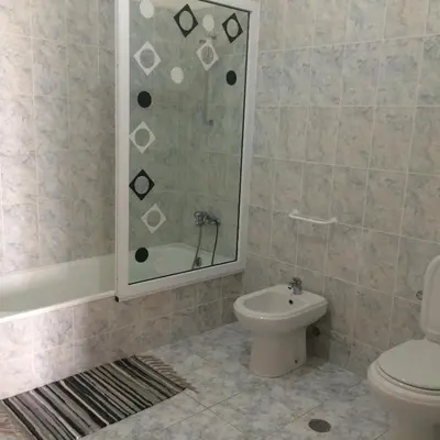 a bathroom with a toilet and a glass shower at Vannilla Residencial in Mindelo