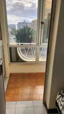 a room with a large window and a wooden floor at Meeting Point Hostels-Praia Beachwalk-NO CASH ACCEPTED-Also in Fogo & Tarrafal in Praia