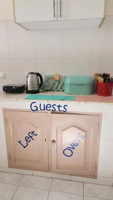 a kitchen counter with the words guests on it at Meeting Point Hostels-Praia Beachwalk-NO CASH ACCEPTED-Also in Fogo & Tarrafal in Praia
