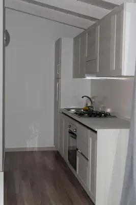 a kitchen with a sink and a stove top oven at Ca Marta Penthouse in Sal Rei
