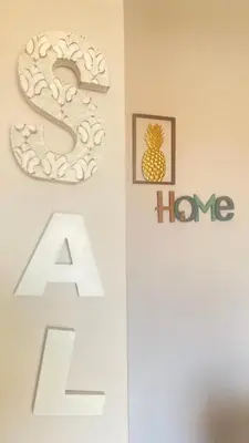 a home sign and a pineapple sign on a wall at SAL at HOME in Santa Maria