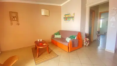a living room with an orange couch and a table at SAL at HOME in Santa Maria