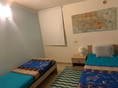 a bedroom with two beds and a painting on the wall at SAL at HOME in Santa Maria