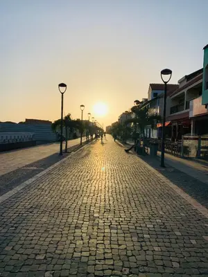 an empty street with the sun setting in the distance at SAL at HOME in Santa Maria
