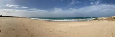 a sandy beach with the ocean in the background at Barracudamaio in Morro