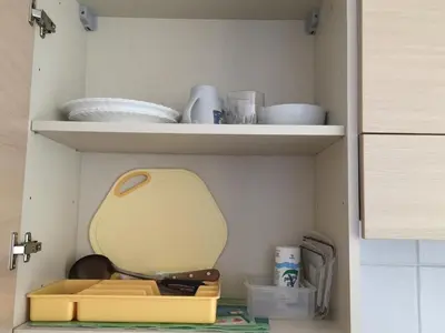a cupboard with plates and dishes in a kitchen at Santa Maria flats in Santa Maria