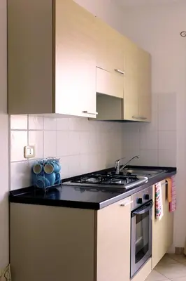 a kitchen with a sink and a stove top oven at Santa Maria flats in Santa Maria