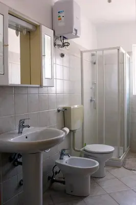a bathroom with a sink and a toilet and a shower at Santa Maria flats in Santa Maria