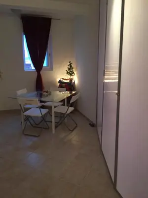 a kitchen with a table and a table and a refrigerator at Santa Maria flats in Santa Maria