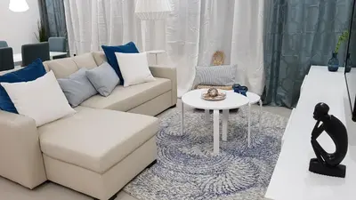 a living room with a couch and a table at Elegant Modern Apartment with AirCond in Praia