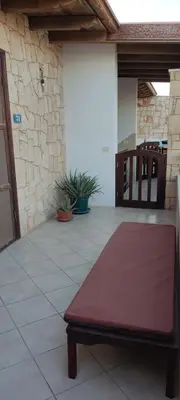 a bench sitting on a tile floor in a patio at Ca' Greta - Big apartment close Estoril beach in Sal Rei