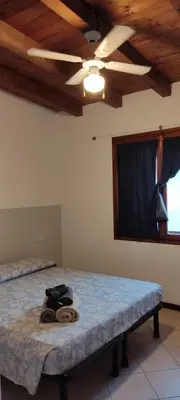 a room with a bed with a ceiling fan at Ca' Greta - Big apartment close Estoril beach in Sal Rei