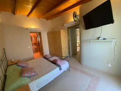 a bedroom with a bed and a flat screen tv at Vista Do Mar Sea View WI-FI FREE Sal Rei in Sal Rei