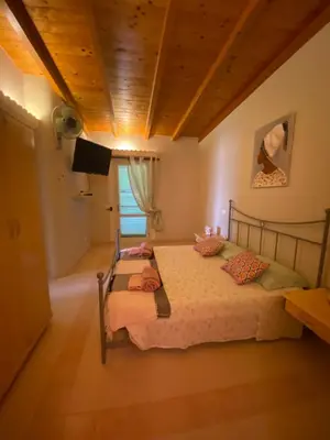 two beds in a bedroom with a wooden ceiling at Vista Do Mar Sea View WI-FI FREE Sal Rei in Sal Rei