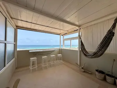 a room with a hammock and a view of the ocean at Vista Do Mar Sea View WI-FI FREE Sal Rei in Sal Rei