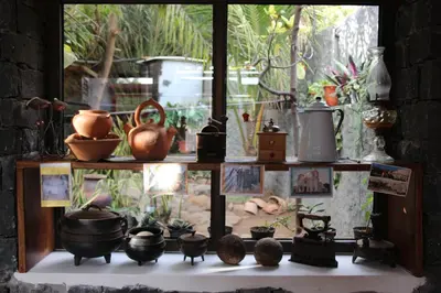 a shelf with pots and other items on it at Pousada Quinta Ribeirinha in Cidade Velha