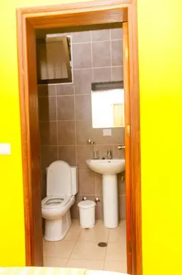 a bathroom with a toilet and a sink at Pousada Quinta Ribeirinha in Cidade Velha