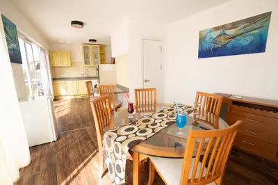 a kitchen and dining room with a table and chairs at Blue Marlin Hotel in Mindelo